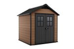 Façade marron de l'abri installée dans un jardin avec double porte