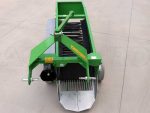 Machine en action déposant des pommes de terre propres sur le sol